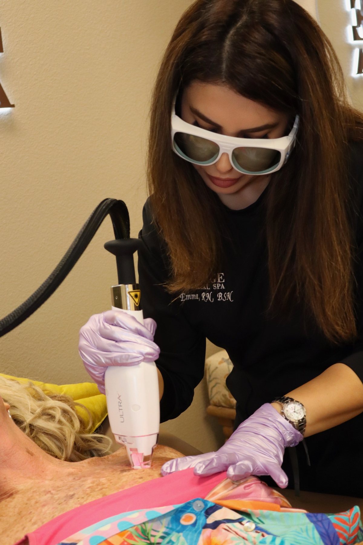 Emma performing an Ultra laser treatment on the upper chest